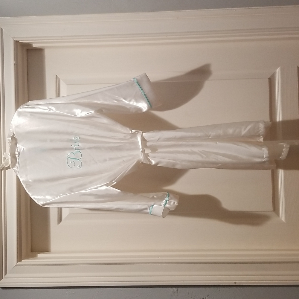 White robe with blue-stitched "Bride" on back